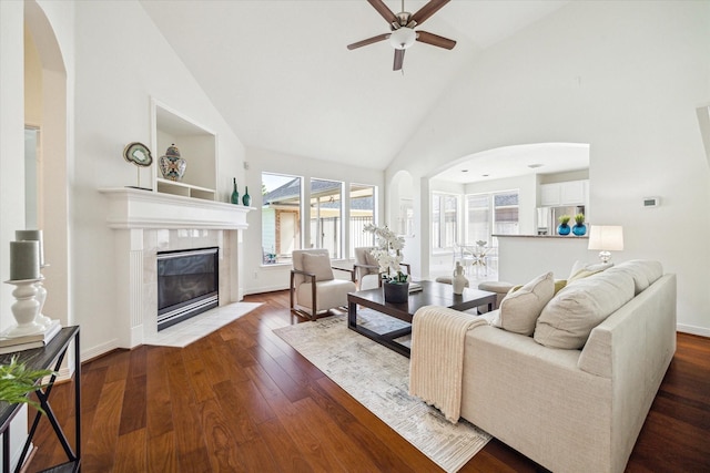 5514 Chase Hbr, Houston, TX 77041 - living area with arched walkways, ceiling fan, high vaulted ceiling, a tile fireplace, and wood finished floors