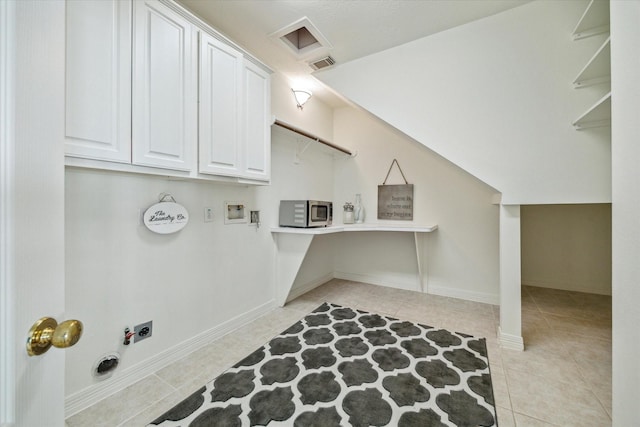 5514 Chase Hbr, Houston, TX 77041 - clothes washing area with cabinet space, hookup for an electric dryer, light tile patterned floors, hookup for a washing machine, and baseboards