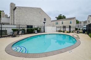 community pool featuring a patio and fence
