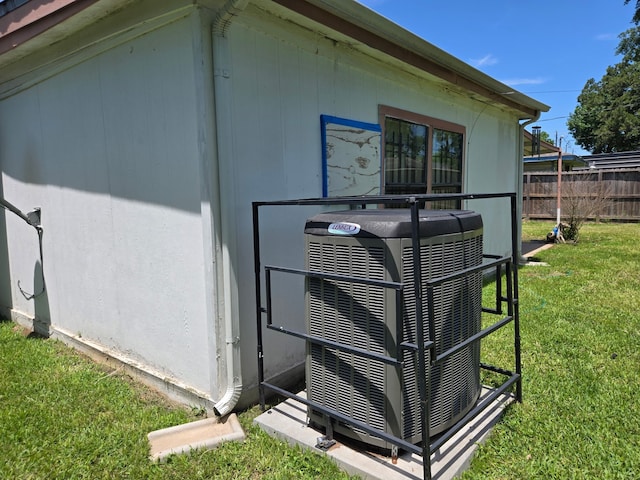 details featuring central air condition unit and fence