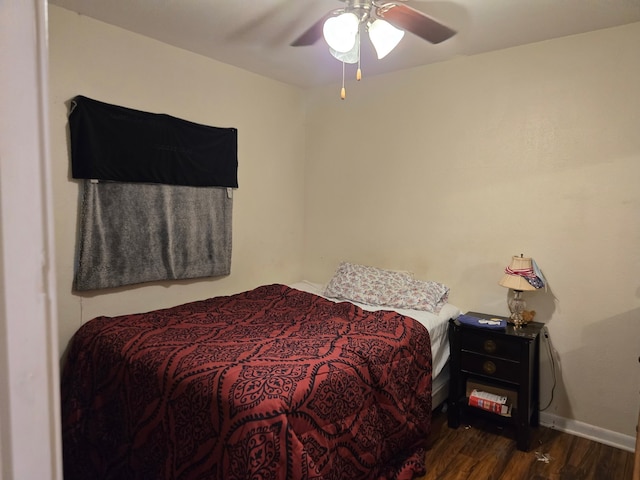 bedroom featuring baseboards, ceiling fan, and wood finished floors