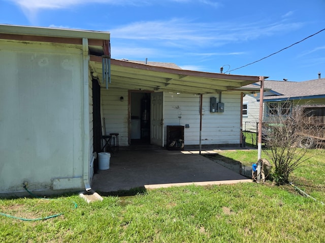 back of property featuring fence and a yard