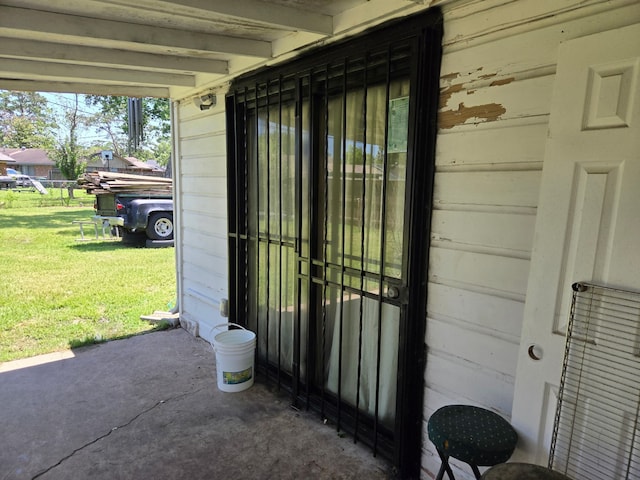 entrance to property featuring a lawn