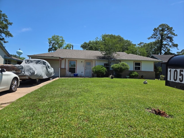 ranch-style home with brick siding, driveway, a front yard, and a garage
