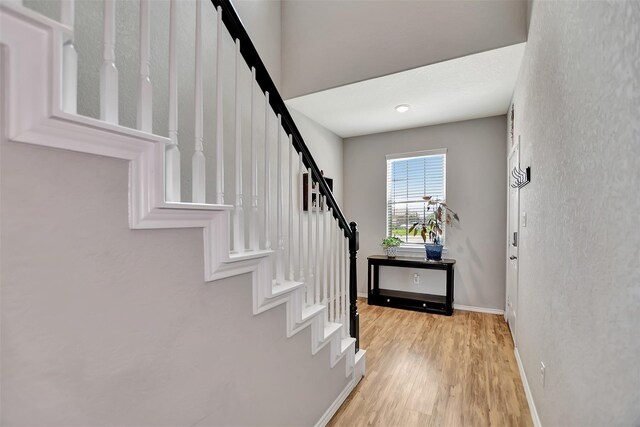 5542 Redwood Summit Ln, Katy, TX 77449 - foyer entrance with stairs, baseboards, and light wood-style flooring