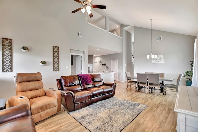 5542 Redwood Summit Ln, Katy, TX 77449 - living room with visible vents, light wood-style flooring, ceiling fan with notable chandelier, and high vaulted ceiling