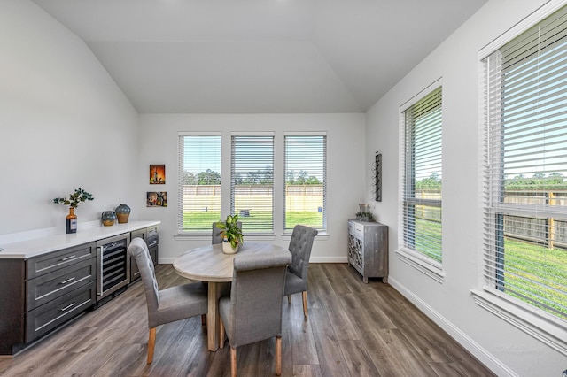41015 Kimber Ln, Magnolia, TX 77354 - dining area featuring beverage cooler, baseboards, dark wood-type flooring, and vaulted ceiling