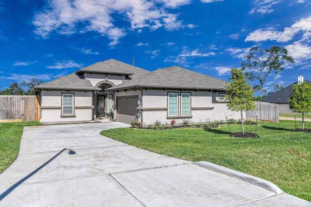 41015 Kimber Ln, Magnolia, TX 77354 - view of front of house featuring fence, an attached garage, stucco siding, a front yard, and driveway
