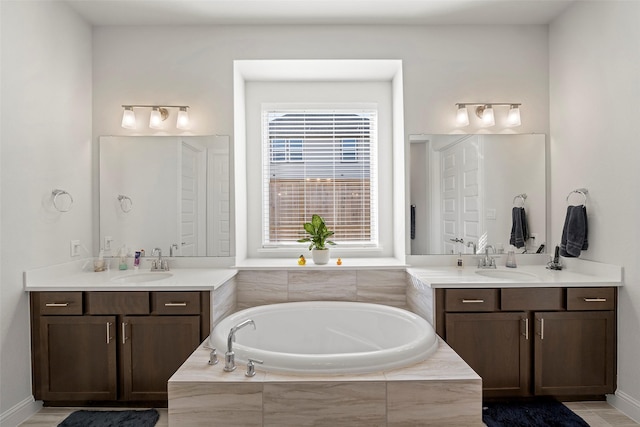 41015 Kimber Ln, Magnolia, TX 77354 - full bath featuring a garden tub, a sink, and two vanities