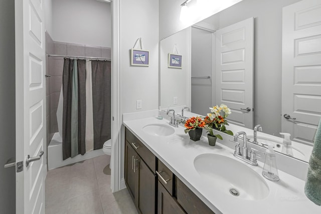 41015 Kimber Ln, Magnolia, TX 77354 - bathroom with double vanity, toilet, tile patterned floors, and a sink