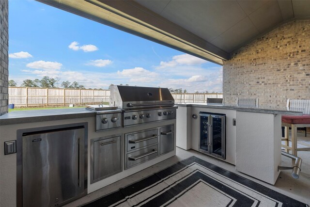 41015 Kimber Ln, Magnolia, TX 77354 - view of patio featuring wine cooler, fence, grilling area, and area for grilling