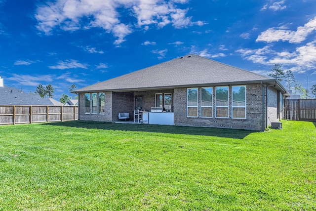 41015 Kimber Ln, Magnolia, TX 77354 - back of property featuring a fenced backyard, a yard, and brick siding