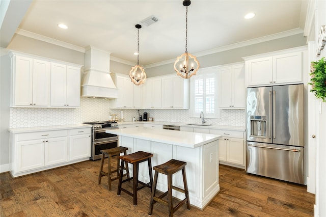 12 Caravelle Ct, Galveston, TX 77554 - kitchen with premium appliances, a sink, premium range hood, a chandelier, and white cabinets