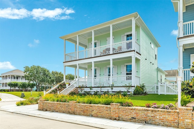 12 Caravelle Ct, Galveston, TX 77554 - view of front of house featuring covered porch and a front yard