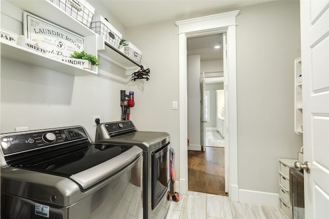 12 Caravelle Ct, Galveston, TX 77554 - laundry area featuring washer and dryer and baseboards
