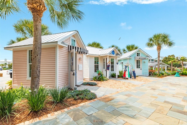 12 Caravelle Ct, Galveston, TX 77554 - rear view of property with metal roof and a standing seam roof