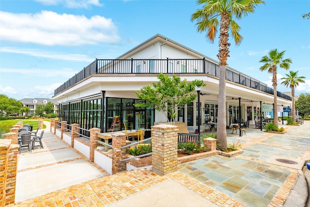 12 Caravelle Ct, Galveston, TX 77554 - view of front of property featuring a balcony, a ceiling fan, and a patio area