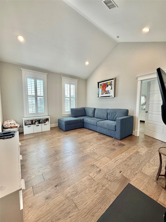 12 Caravelle Ct, Galveston, TX 77554 - living room with wood finished floors, vaulted ceiling, recessed lighting, and baseboards