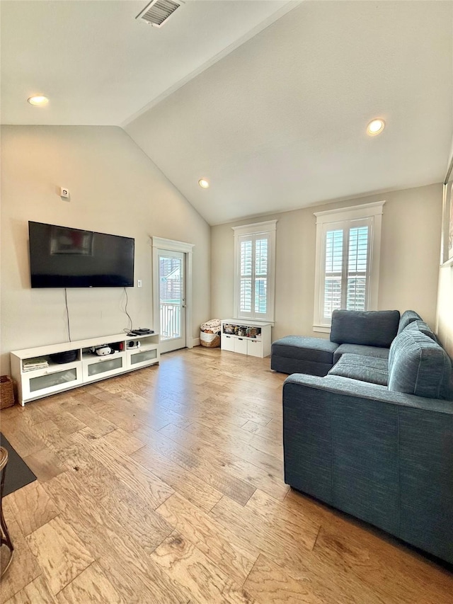 12 Caravelle Ct, Galveston, TX 77554 - living area with vaulted ceiling, wood finished floors, and recessed lighting
