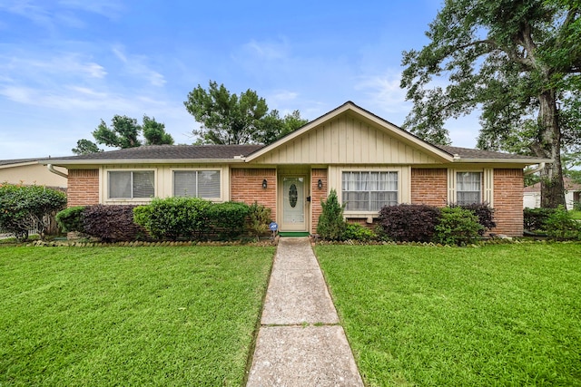 single story home with brick siding and a front yard
