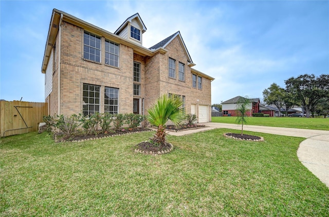 view of front of home with brick siding, fence, a front lawn, concrete driveway, and an attached garage