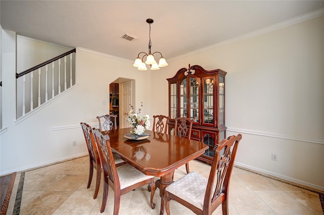dining space with crown molding, an inviting chandelier, arched walkways, baseboards, and visible vents