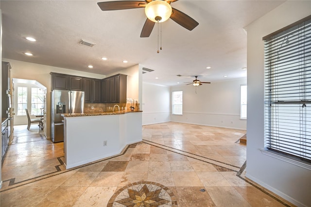 kitchen featuring a ceiling fan, stainless steel refrigerator with ice dispenser, visible vents, baseboards, and recessed lighting