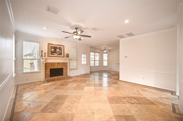 unfurnished living room featuring baseboards, a ceiling fan, a brick fireplace, and ornamental molding