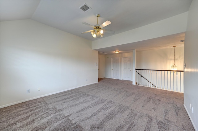 unfurnished room featuring visible vents, carpet, a ceiling fan, baseboards, and vaulted ceiling