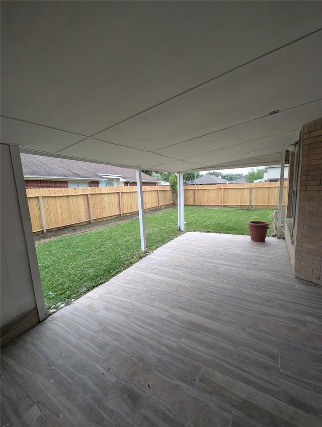 wooden terrace with a yard and a fenced backyard