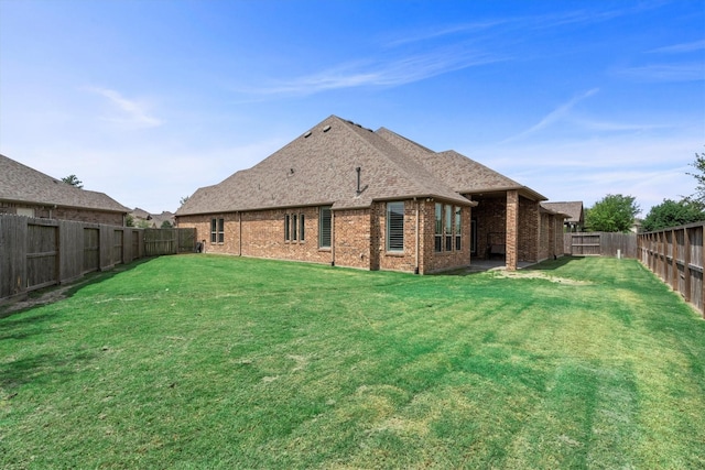 19506 Timberlake Glen Trl, Cypress, TX 77433 - back of property featuring a lawn, brick siding, a fenced backyard, and roof with shingles
