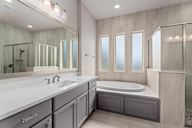 19506 Timberlake Glen Trl, Cypress, TX 77433 - bathroom with vanity, recessed lighting, visible vents, a bath, and a stall shower