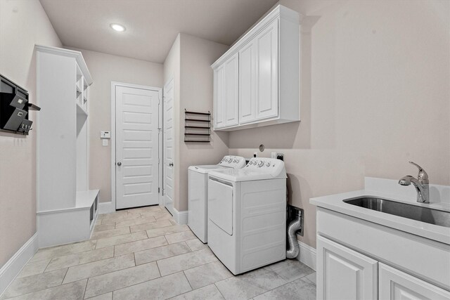 19506 Timberlake Glen Trl, Cypress, TX 77433 - laundry area with cabinet space, a sink, baseboards, recessed lighting, and washer and dryer