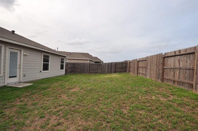 view of yard with a fenced backyard