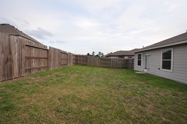 view of yard with a fenced backyard