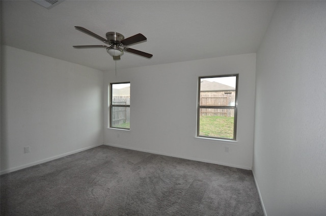 unfurnished room with carpet floors, plenty of natural light, baseboards, and ceiling fan
