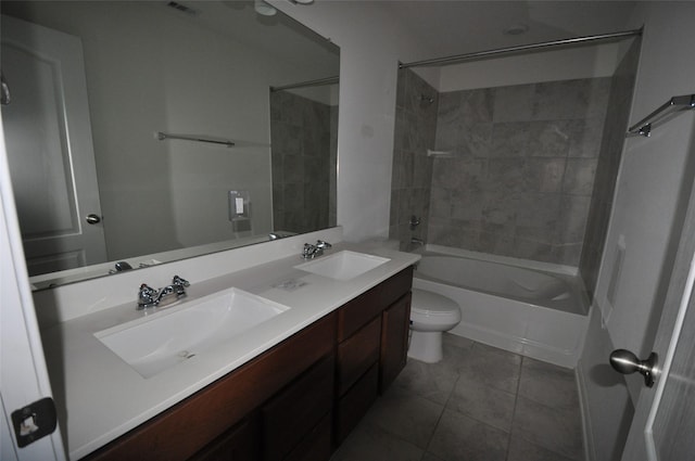 full bathroom with double vanity, toilet, washtub / shower combination, and a sink