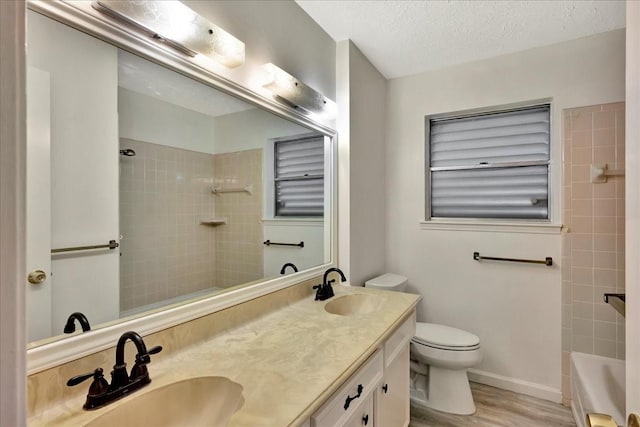 11438 Sageyork Dr, Houston, TX 77089 - bathroom with a sink, a textured ceiling, toilet, and double vanity