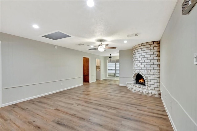 11438 Sageyork Dr, Houston, TX 77089 - unfurnished living room with ceiling fan, a fireplace, light wood-style flooring, and visible vents