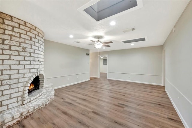 11438 Sageyork Dr, Houston, TX 77089 - unfurnished living room with visible vents, wood finished floors, baseboards, ceiling fan, and a skylight