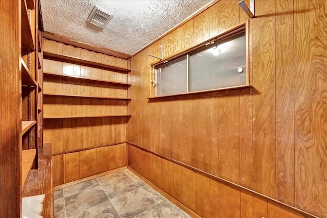 11438 Sageyork Dr, Houston, TX 77089 - interior space with wood walls, a textured ceiling, and visible vents