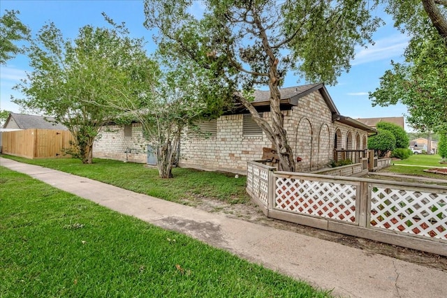 11438 Sageyork Dr, Houston, TX 77089 - view of property exterior with a yard, fence, and stone siding