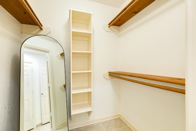 spacious closet featuring light tile patterned floors
