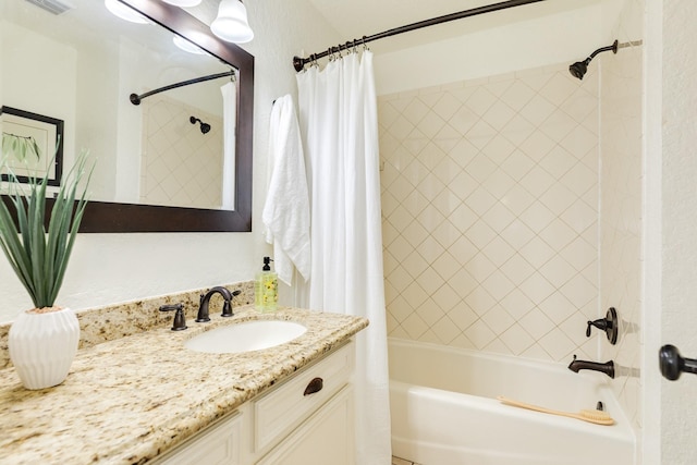 bathroom with vanity, visible vents, and shower / tub combo with curtain