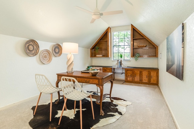 home office with baseboards, ceiling fan, light carpet, and lofted ceiling