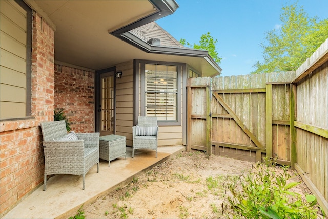 view of patio with a gate and fence