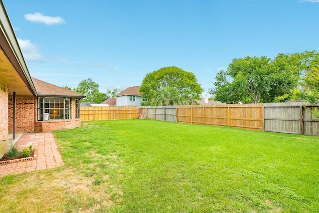 view of yard with a fenced backyard