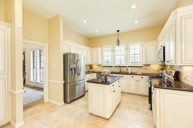 kitchen with a sink, tasteful backsplash, stainless steel appliances, and recessed lighting