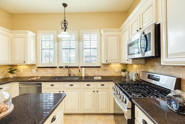 kitchen with stainless steel appliances, plenty of natural light, and a sink