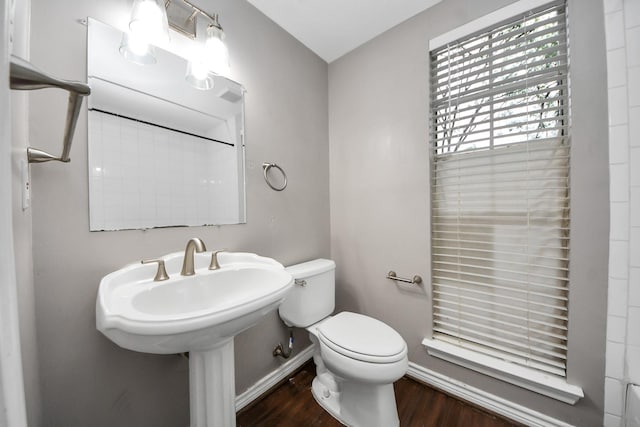 15510 Jersey Dr, Jersey Village, TX 77040 - bathroom with baseboards, toilet, and wood finished floors